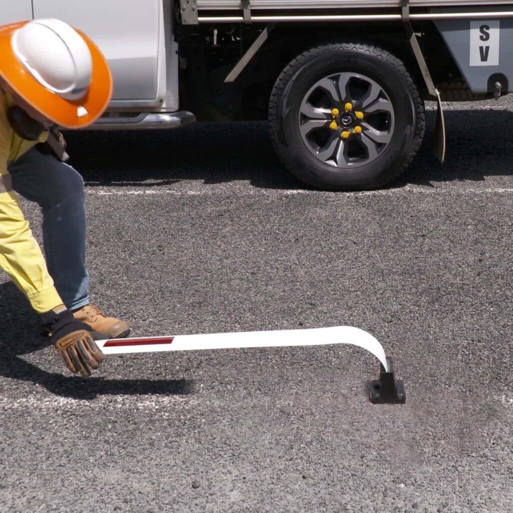 Flexi-T safety bollard being bent by a construction worker
