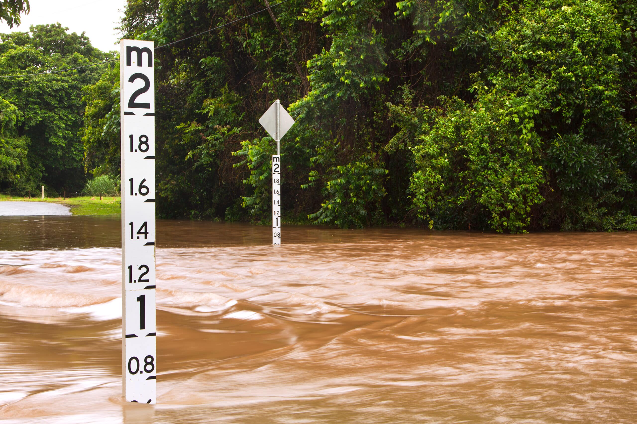 Flooded road with depth indicators in Queensland, Australia