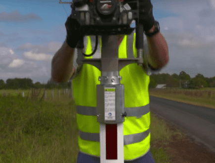 A construction worker installing steel-flex barriers
