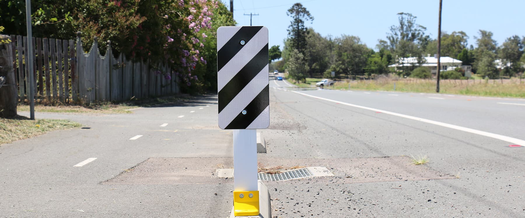 A black and white surface mounted road sign