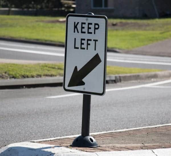 Keep left sign on a short flexible support
