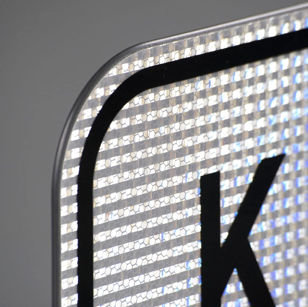 The corner of a reflective keep left sign