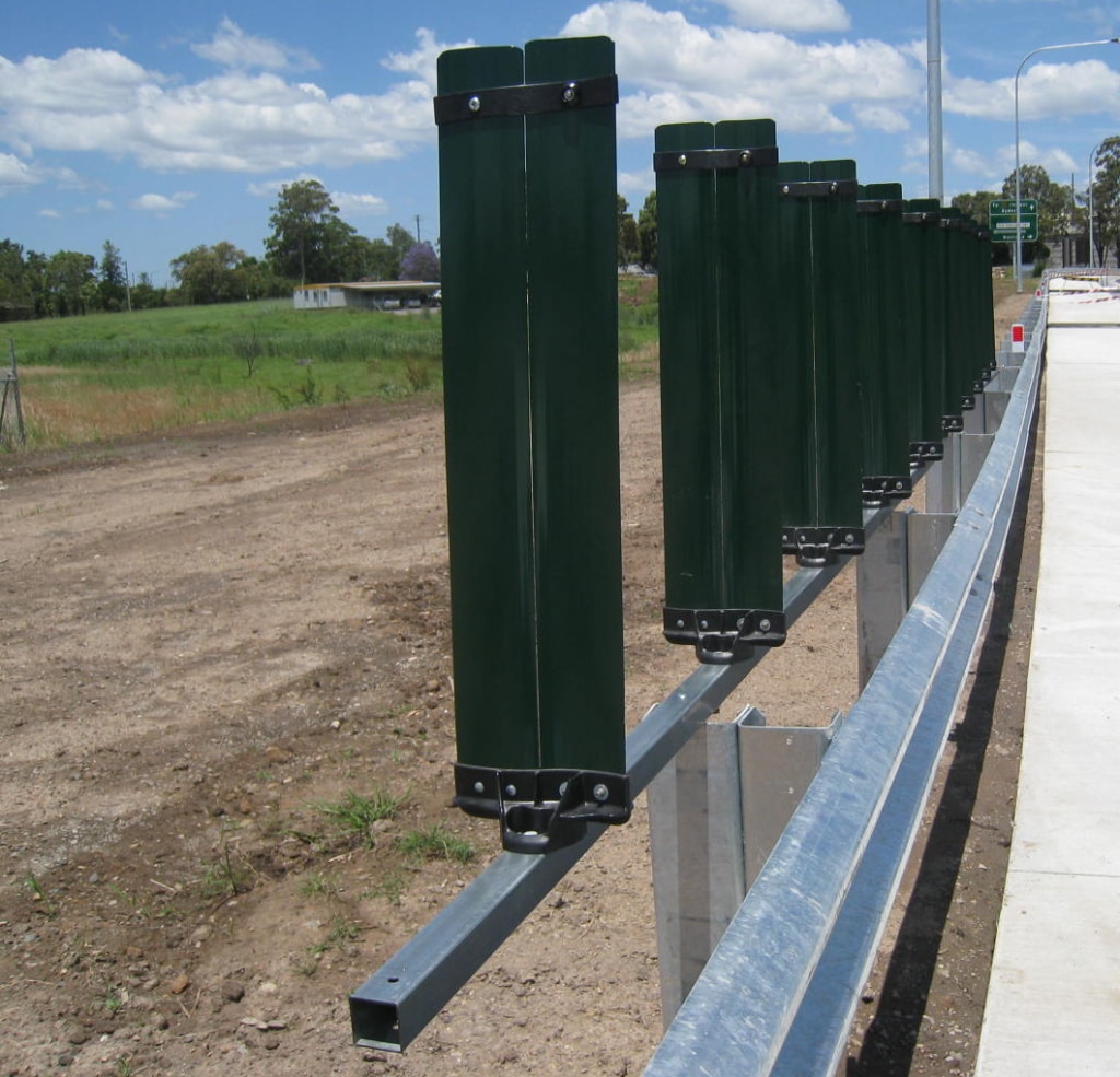 Green glare-flex posts installed on a guardrail