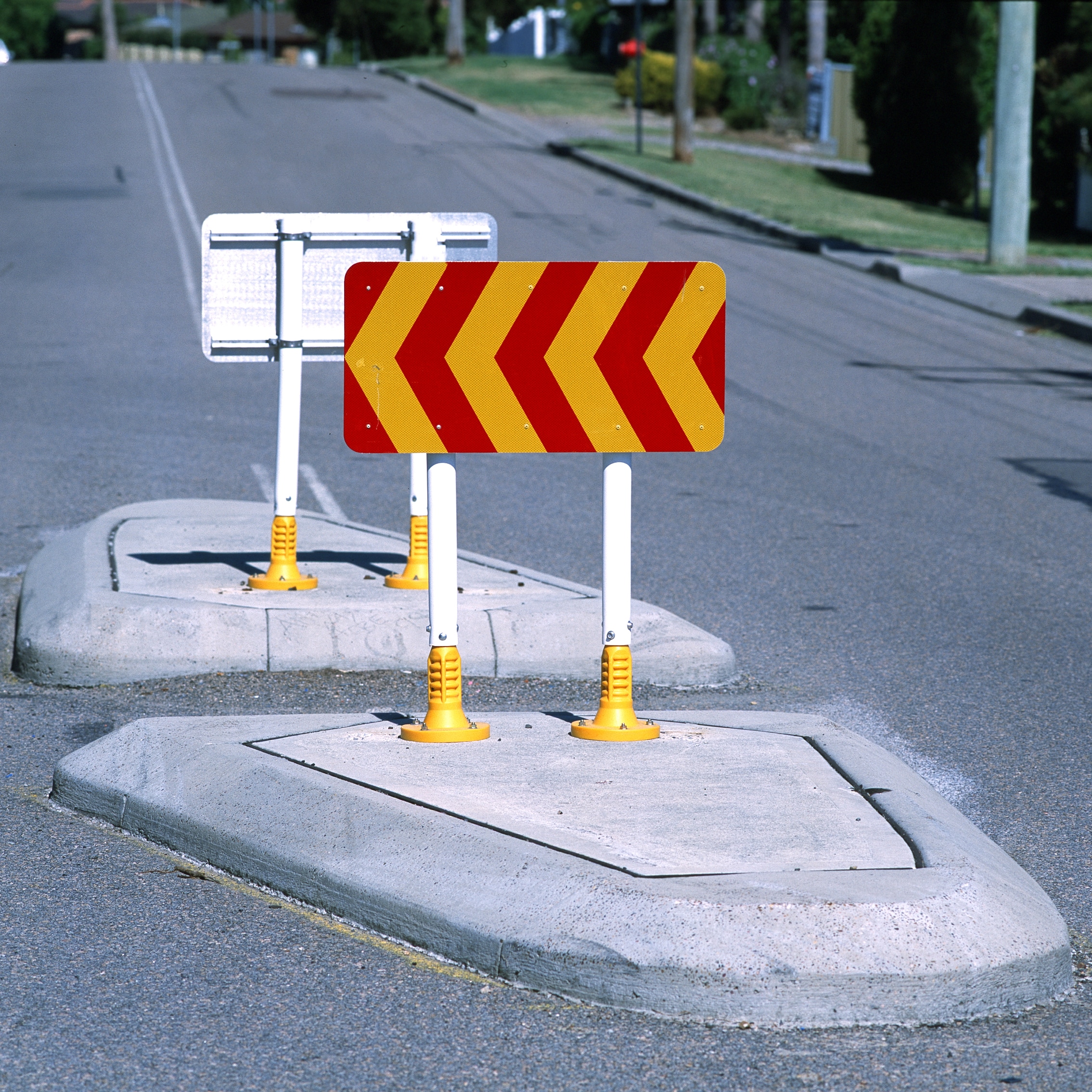Red and yellow poly-flex signs installed on a road