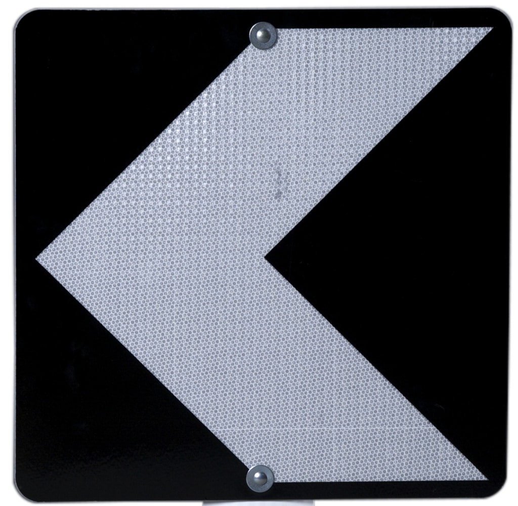 Impact road sign with white arrow