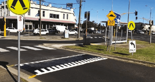 Rubber speed cushion installed next to a pedestrian crossing