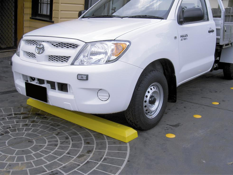A ute parked at a wheel Stop